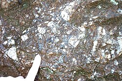 Hydrothermal breccia in the Cloghleagh Iron Mine, near Blessington in Ireland, composed mainly of quartz and manganese oxides, the result of seismic activity about 12 million years ago