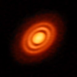 Primordial cloud of gas and dust surrounding the young star HD 163296.[13]