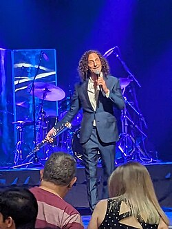 Kenny G onstage before his concert at People's Bank Theatre, Marietta, Ohio, on 9 July 2023, announcing that one of his saxophones would be auctioned for charity