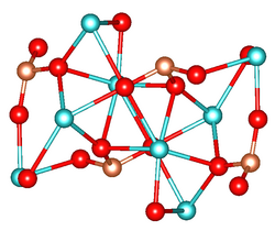 Unit cell of Ca2SiO4. Color code: red (O), blue (Ca), gold (Si).