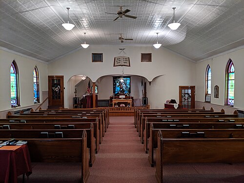 Artwork on the chancel arch of White Memorial Wesleyan Methodist Church in Struthers depicting the biblical verse on the New Birth (first work of grace): "Ye must be born again" (John 3:7), a core Methodist doctrine.