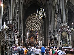 Cathedrals often contain a wealth of artworks. Tourists visiting the interior of St. Stephen's Cathedral, Vienna.