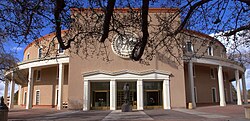 The New Mexico State Capitol, commonly known as The Roundhouse, was built in a Territorial Revival style.