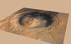 Aeolis Mons rises from the middle of Gale Crater – Green dot marks the Curiosity rover landing site in Aeolis Palus[95][96] – North is down.