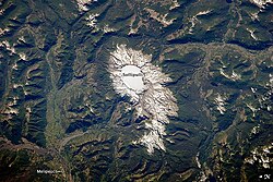Sollipulli Caldera, located in central Chile near the border with Argentina, filled with ice. The volcano is in the southern Andes Mountains within Chile's Parque Nacional Villarica.[38]