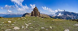 Cairn out of porphyr rocks on the alpine pasture Resciesa in Gherdëina, an Unesco World Heritage.