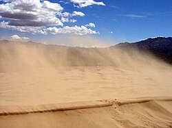 Sand blowing off a crest in the Kelso Dunes of the Mojave Desert, California