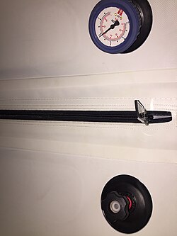 Pressure release valve and pressure gauge inside a flexible low pressure hyperbaric oxygen therapy chamber