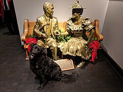 A life-sized statue of Acuff sits on a pew alongside a statue of Minnie Pearl in the lobby of Ryman Auditorium.