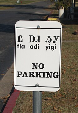 Cherokee traffic sign in Tahlequah, Oklahoma, reading "tla adi yigi", meaning "no parking" from "tla" meaning "no"