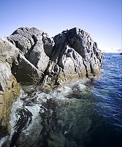 Waves and water chemistry lead to structural failure in exposed rocks.