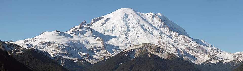 Mount Rainier with its main summit, Columbia Crest (14410 feet) at the center. Emmons Glacier covers most of the visible flank of the mountain with Disappointment Cleaver visible below Gibraltar Rock, right of the sharp pointed Little Tahoma (11138 feet). Liberty Cap (14112 feet) is visible on the right center skyline behind Russell Cliff.