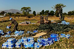 Nepalese members of MINUSTAH secure an airdrop of aid supplies in Mirebalais in January 2010