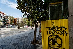 Graffiti "Tourists fuck off" in Madrid.