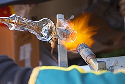 Glass can be fairly easily melted and manipulated with a heat source