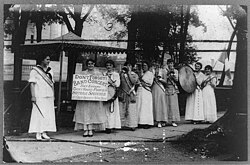 Suffragists with instruments advertise a show in Hackensack, New Jersey.