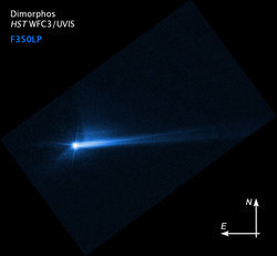 Dimorphos and the tail created after the DART impact, photo by the Hubble Space Telescope