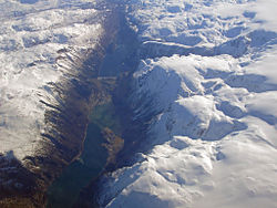Fjords often continue as U-shaped valleys above sea level and freshwater fjord lakes: Sørfjorden (Hardanger) can be seen here transitioning into Sandvinvatnet and the Odda Valley. Odda sits on the isthmus, Folgefonna on the right.