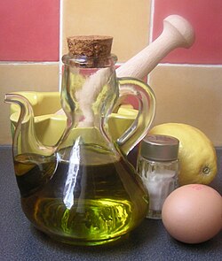 An example of the ingredients used to make mayonnaise; olive oil, table salt, an egg (for yolk) and a lemon (for lemon juice). The oil and water in the egg yolk do not mix, while the lecithin in the yolk serves as an emulsifier, allowing the two to be blended together.