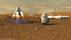 Artist's conception of two Red Dragon capsules on Mars, next to an outpost