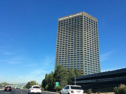 10 Universal City Plaza (in Los Angeles County) in 2015 after Comcast acquired GE's remaining stake in NBCUniversal. Notice the wording on the top of the building changed. The Comcast headquarters can be seen at Universal Studios Hollywood.