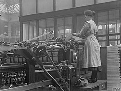 A worker operating a laying machine in the printing works of WH Smith & Sons, Stamford Street, Southwark, 1918