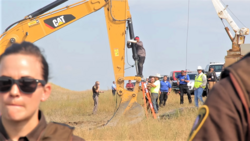 Lakota man locks himself to construction equipment to stop progress of the Dakota Access Pipeline near the Standing Rock Reservation in North Dakota, Summer 2016