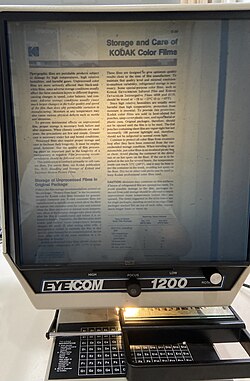 An EYECOM 1200 microfiche reader projecting a standard 24X microfiche containing kodak technical publications. Note the brightness "hot spot" at the center that was a common complaint concerning back-projection readers. The lamp is in need of replacement, giving light that is yellower and dimmer than normal.