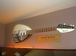 A guitar hanging on a wall