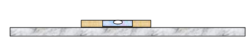 Spirit level bubble on a marble shelf tests for horizontality