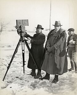 Billy Bitzer (behind Pathé camera) with Griffith on location