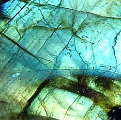 Labradorite displaying typical iridescent effect termed labradorescence (unknown scale)