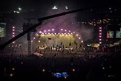 Adele on the Pyramid Stage at Glastonbury in 2016. Having been going to the festival since she was a child, an emotional Adele cried before she went on stage to 150,000 people.[146]
