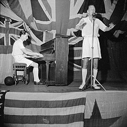 Coward, with Norman Hackforth at the piano, performing for sailors aboard HMS Victorious in Ceylon, 1 August 1944