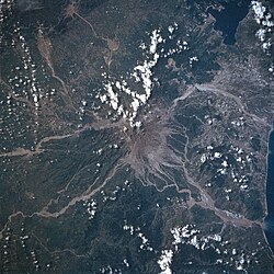 Mount Pinatubo as seen from Space Shuttle Atlantis in 1992. Thick ash and lahar deposits on the volcano and in surrounding river valleys are evident.