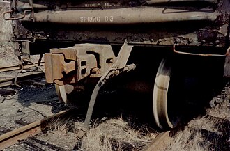 Modern US boxcar showing automatic coupler, air brake hose and grab bars, all mandated by the Safety Appliance Act. The bent rod at far left allows the coupler to be disengaged by a worker standing safely at the side of the car, per Section 2 of the Act.