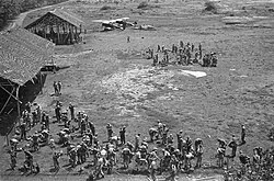 Dutch troops at Maguwo airfield with captured Indonesian Air Force biplanes in the background, 19 December 1948