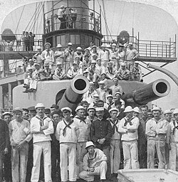 Crewmen pose under the gun turrets of Iowa in 1898.