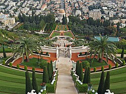 Elaborate gardens with several gates and a walkway leading to a domed building in the distance