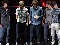 The five members of One Direction on stage