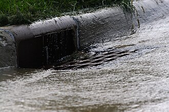 Urban runoff flowing into a storm drain