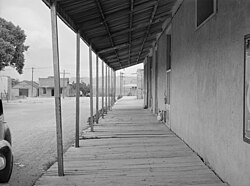 A covered board sidewalk was on 5th Street, just north of Allen Street, in May 1940. Jack Crabtree's Livery Stable and the San Jose Lodging House is on the left.
