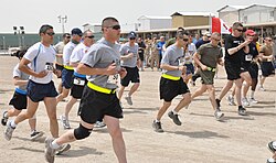 Service members and civilians stationed at Kandahar Airfield, Afghanistan, start the 24-Hour Run for Charity, 16 April 2011.