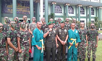 Indonesian Army privates pose with two officers