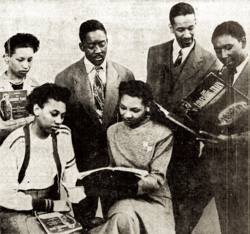Leontyne Price (seated bottom left) rehearses Millard Lampell's ballad opera The Lonesome Train at the State College of Education and Industrial Arts in 1948. Seated next to her is her professor Beatrice O'Rourke who is the director of this ensemble.[39]