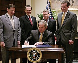 Senator DeWine (second from right) attending the signing of the Safe and Timely Interstate Placement of Foster Children Act by President George W. Bush in 2006