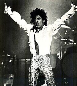 Prince performing with a microphone in hand