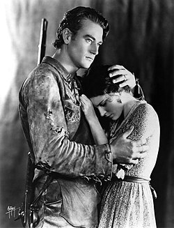 Wayne with Marguerite Churchill in the widescreen The Big Trail (1930), his first role as a leading man