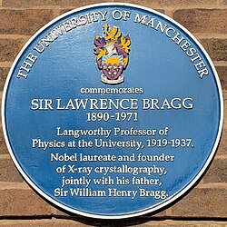 A blue plaque commemorating Bragg's work at the University of Manchester.