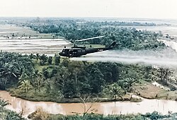 U.S. Army Huey helicopter spraying Agent Orange during the Vietnam War
